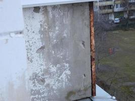 Old cracked balcony railing slab in need of repair photo