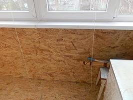 Warming and cladding with slabs of a balcony in an apartment house photo