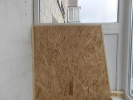 Warming and cladding with slabs of a balcony in an apartment house photo