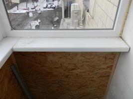 Warming and cladding with slabs of a balcony in an apartment house photo