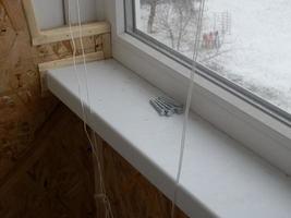 Warming and cladding with slabs of a balcony in an apartment house photo