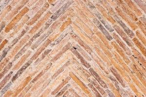 Background of old bricks laid in a herringbone pattern on a vault of a 17th century building photo