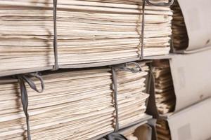 Old files stacked in folders background. Stacks of weathered working Paper documents photo