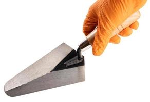 Hand Holding a Trowel isolated on White Background. Construction industry. Copy space photo