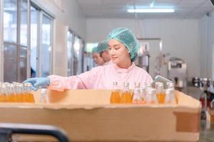 quality supervisor or food or beverages technician inspection about quality control food or beverages before send product to the customer. Production leader recheck ingredient and productivity. photo