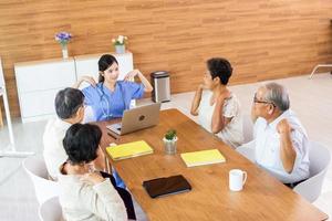 Nursing Home Care concept. A group of elderly people in nursing homes meeting with nursing care assistants photo