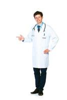 Portrait of a smiling young male doctor pointing sideways isolated on white photo