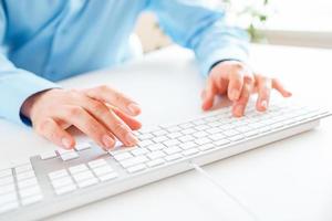 Men office worker typing on the keyboard photo