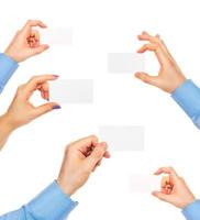 Business cards in hands on white photo