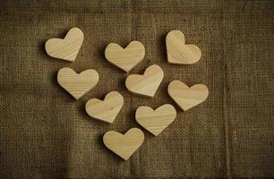 Wooden hearts on sackcloth background photo
