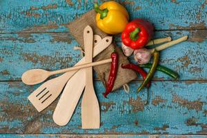 de madera cuchillería y diferente vegetales en desgastado azul antecedentes foto