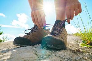 Hiking shoes - woman tying shoe laces photo