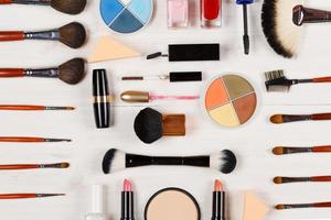 Various makeup products on wooden background photo