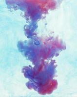 Color drop underwater creating a silk drapery. Ink swirling underwater photo