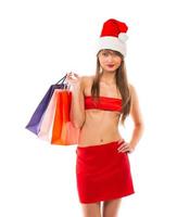 Beautiful Santa christmas girl with shopping bags on white photo