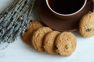 Lavender, cookies and cup of tea on white wooden background photo