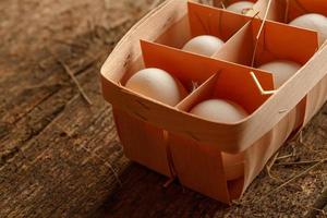 Fresh chicken eggs on a wooden  background photo