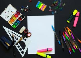 School supplies on blackboard background ready for your design photo