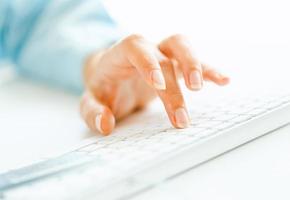 Woman office worker typing on the keyboard photo