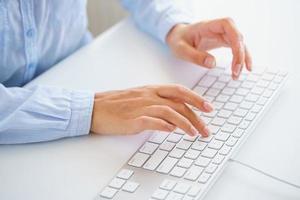 Male hands typing on the keyboard photo