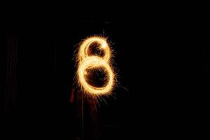 Number made with sparklers ready for your inscriptions on black background photo