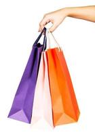 Woman's hand holding colorful shopping bags photo