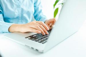 Woman office worker typing on the keyboard photo