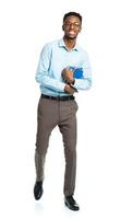 Happy african american college student with books in his hands standing on white photo