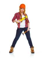 Young woman worker in helmet with the work tools on a white photo