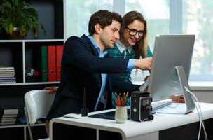 Young colleague - man and woman working from home - modern business concept photo