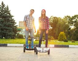 Young couple riding hoverboard photo