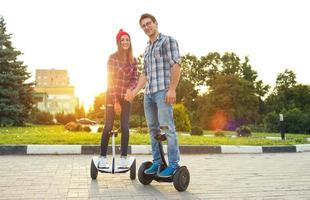 Young couple riding hoverboard photo