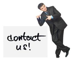 Young businessman points on a card Contact Us on a white photo