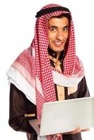 Young smiling arab with laptop isolated on white photo