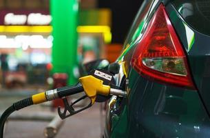 Car refueling on a petrol station in winter at night photo