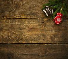 Christmas tree branches with christmas decorations on wooden texture ready for your design photo