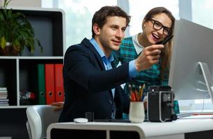 Beautiful young woman and man working from home photo