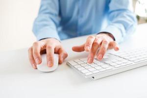 Men office worker typing on the keyboard photo