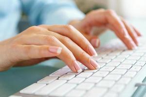 Woman office worker typing on the keyboard photo