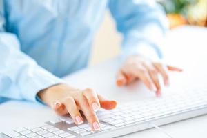 Woman office worker typing on the keyboard photo