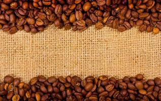 Coffee grains on the burlap background photo