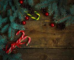 Navidad frontera con pino árbol sucursales, conos, Navidad decoraciones y caramelo caña foto