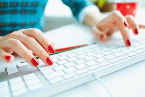 Woman office worker typing on the keyboard photo