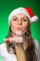 Girl in a Christmas hat and snowflakes photo