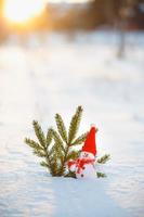 Happy snowman standing in winter christmas landscape.Snow background photo