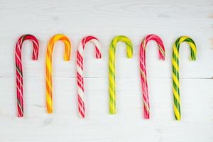 Christmas candy cane on a wooden background photo