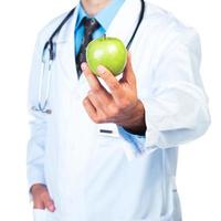 Doctor's hand holding a fresh green apple close-up photo