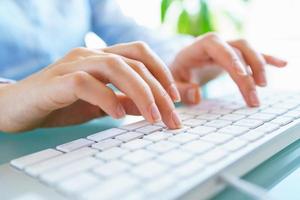 Woman office worker typing on the keyboard photo