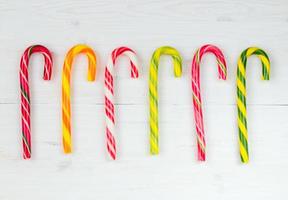 Christmas candy cane on a white wooden background photo