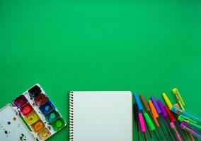 School supplies on blackboard background ready for your design photo